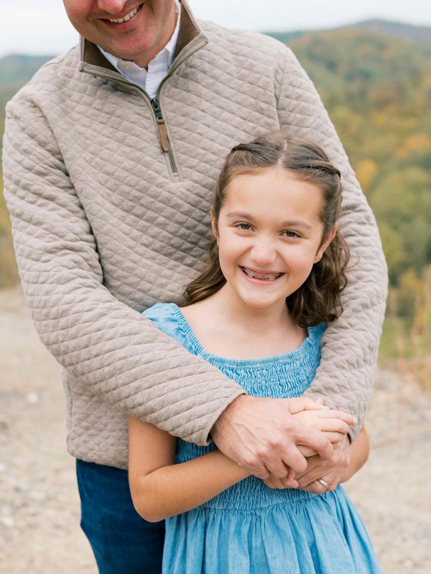 Dad and daughter playing and laughing during outdoor family session in Mobile Alabama