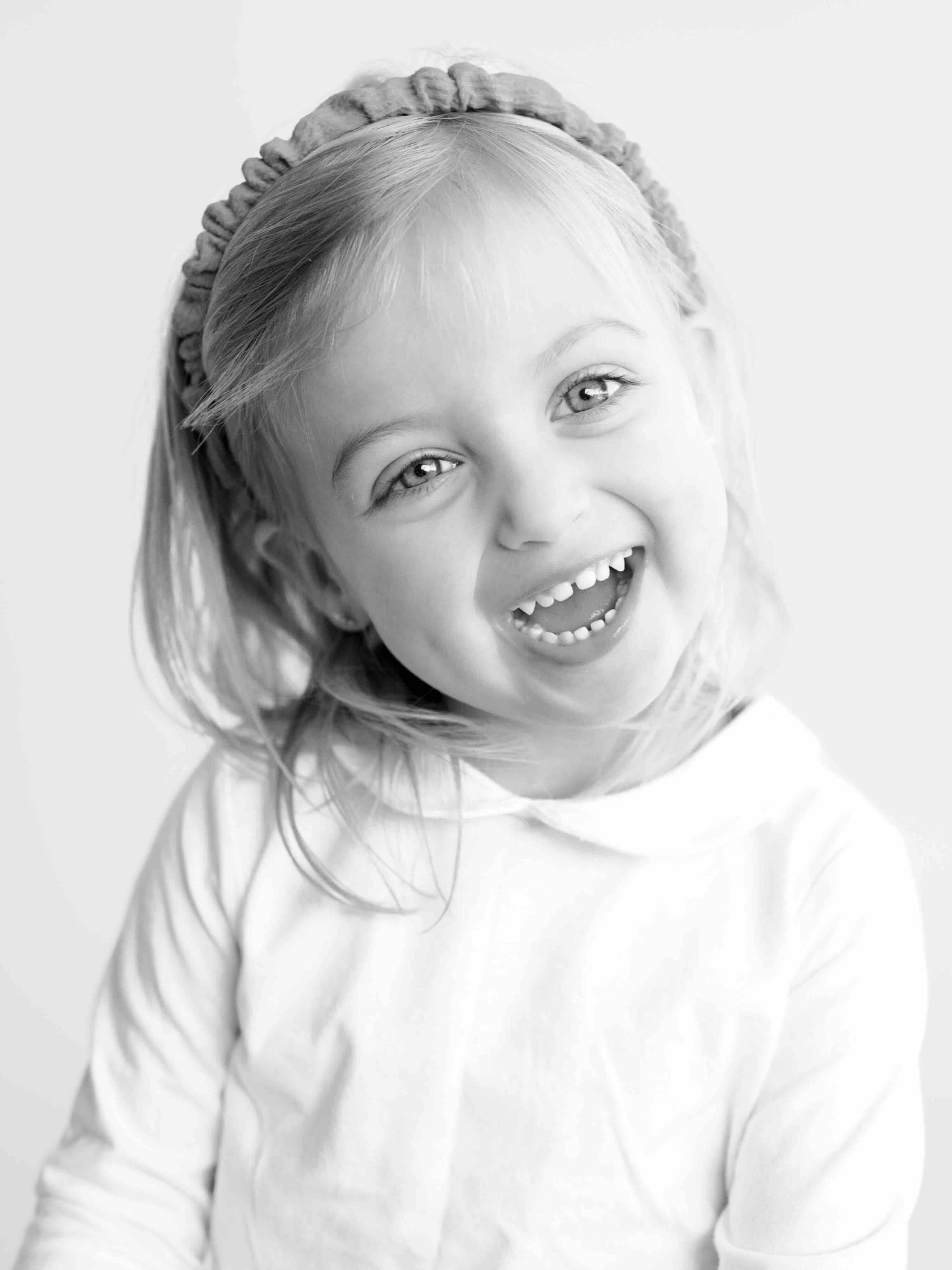 Little girl showing playful personality during Little Snaps portrait session