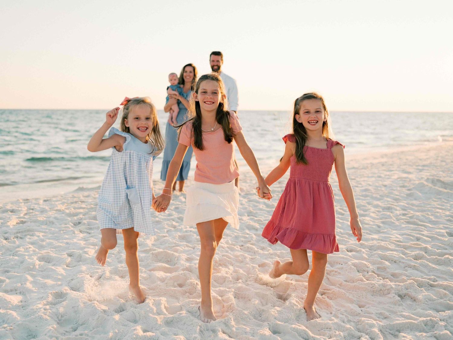 Girls running and playing during golden hour photography session in Dauphin Island Alabama