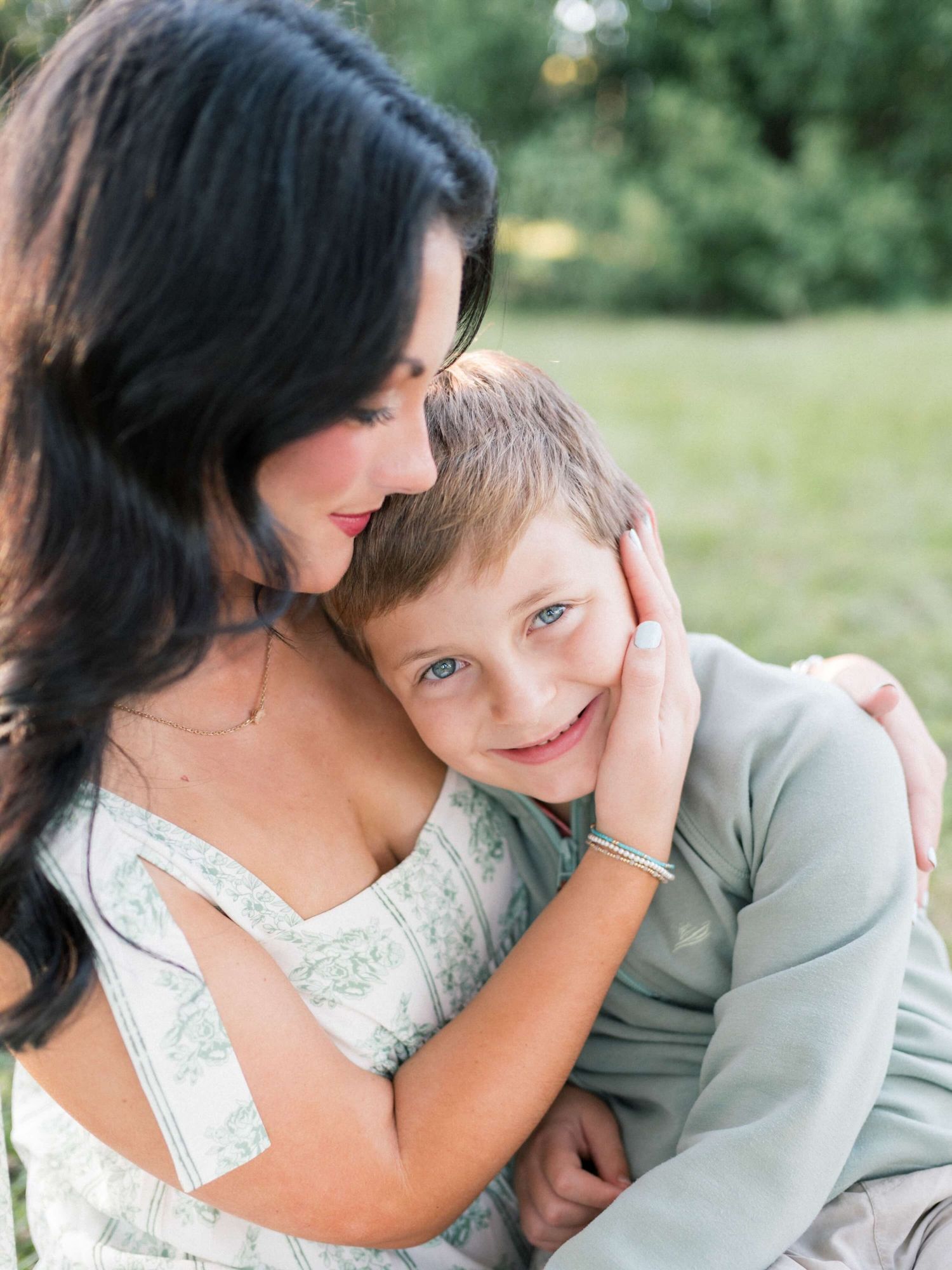 Mother holding son at sunset during Springhill College family photography session