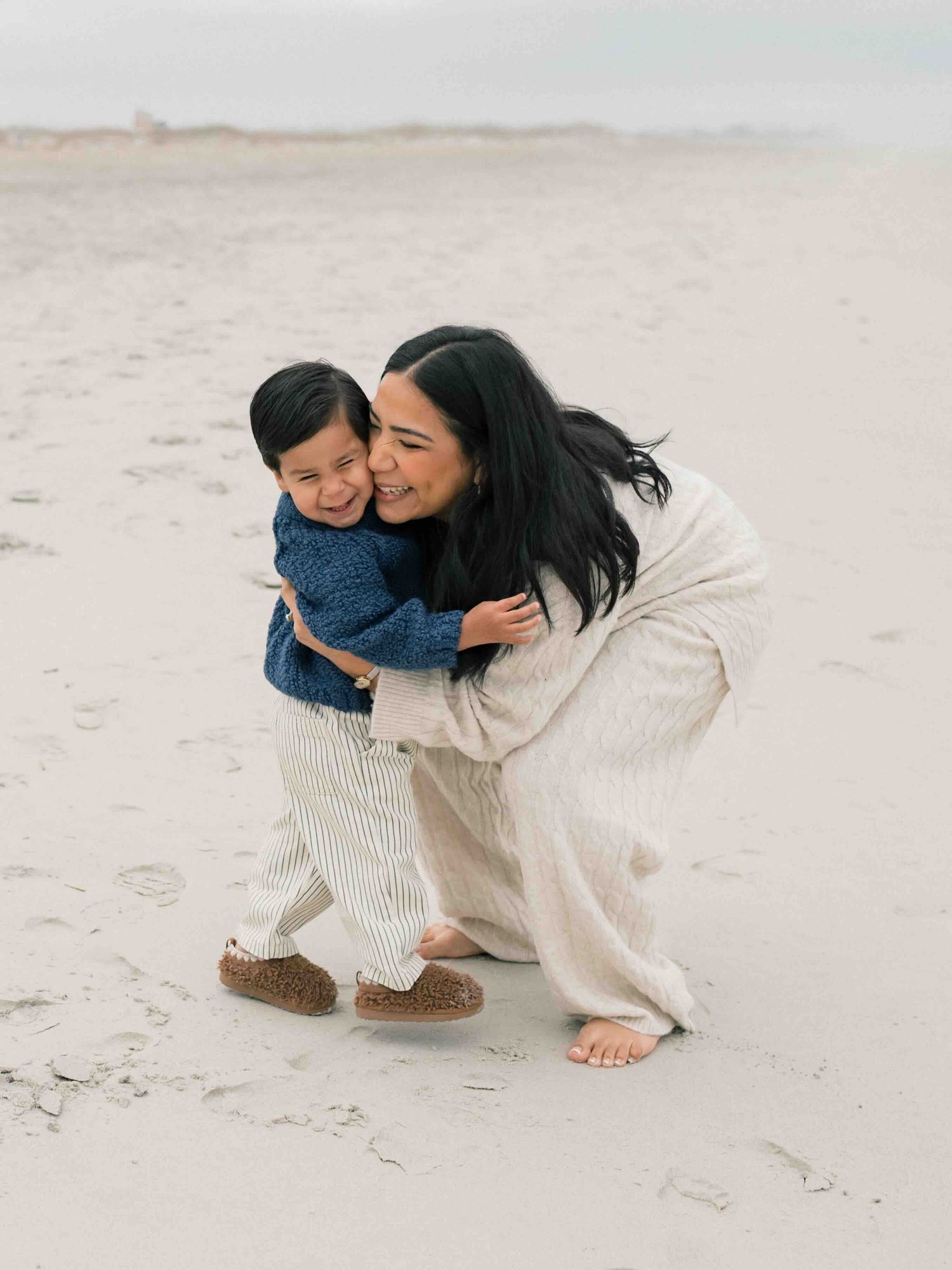 Mother holding toddler at sunset during Mobile Alabama family photography session