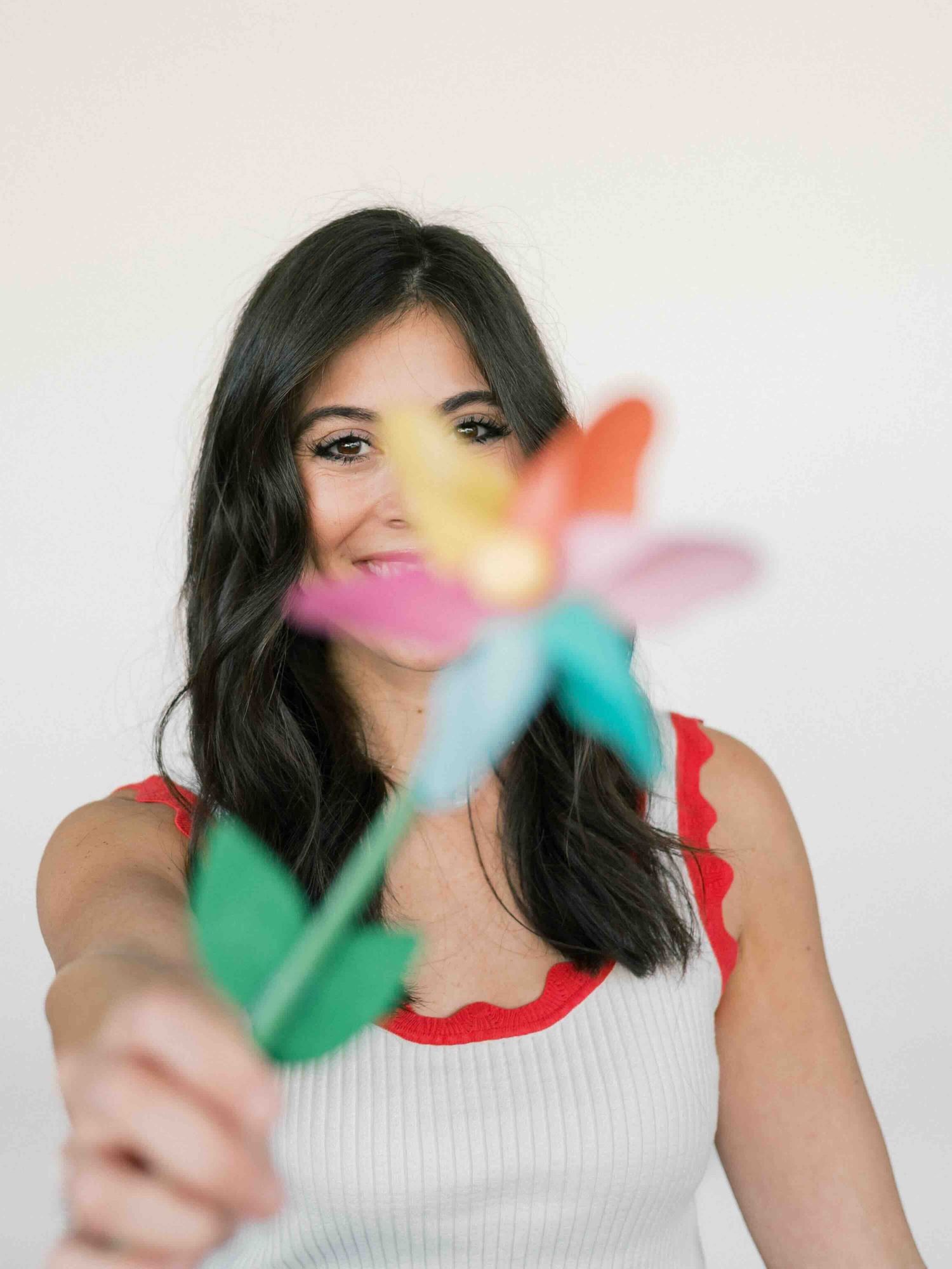 woman holding a colorful fan during portrait session in mobile alabama