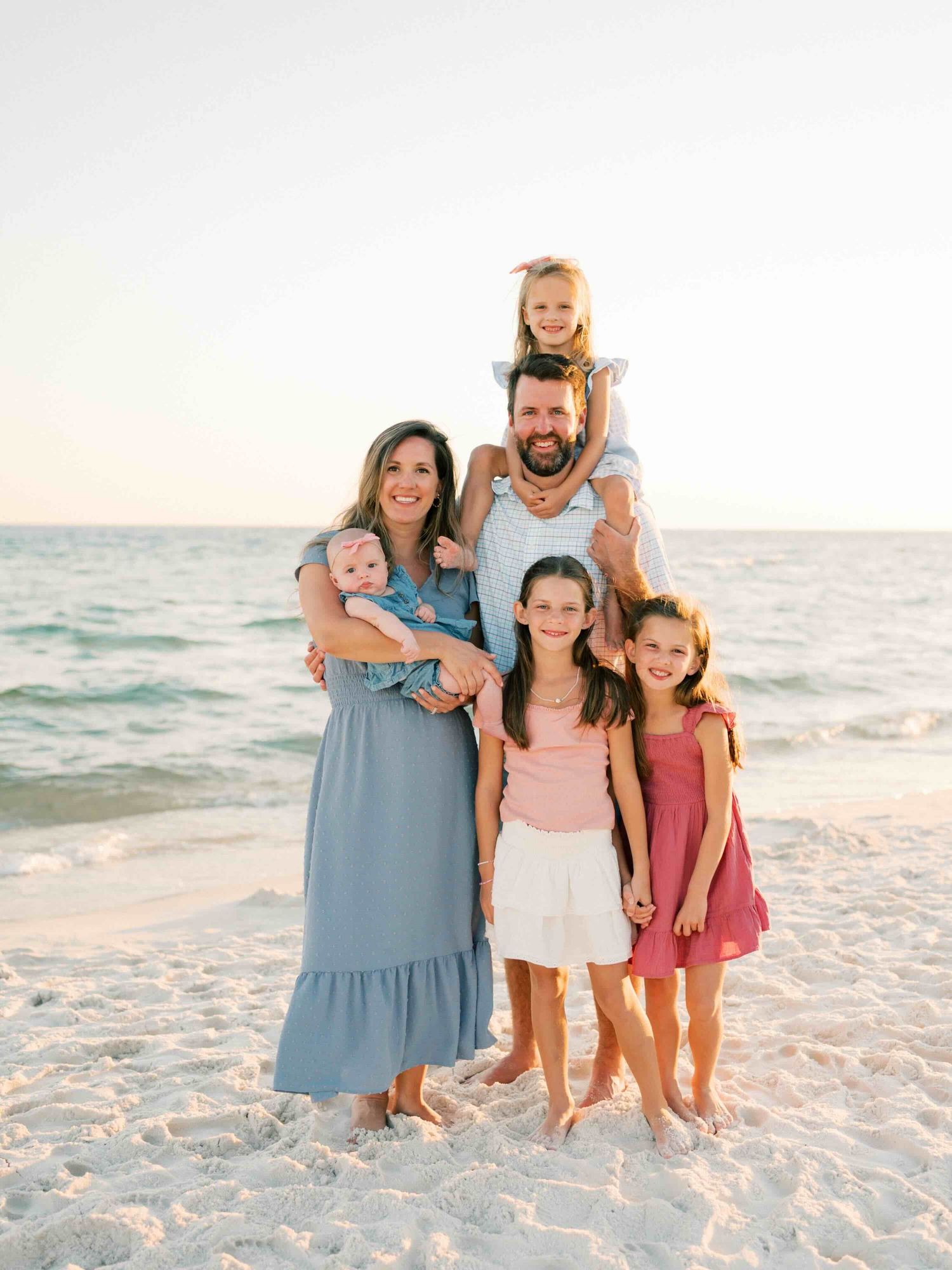 Parents and children playing together during family photography session in Orange Beach Alabama