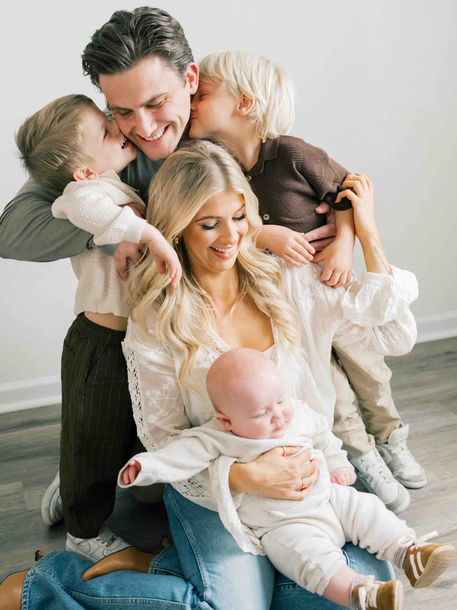 Family embracing during family photography session in Fairhope, Alabama