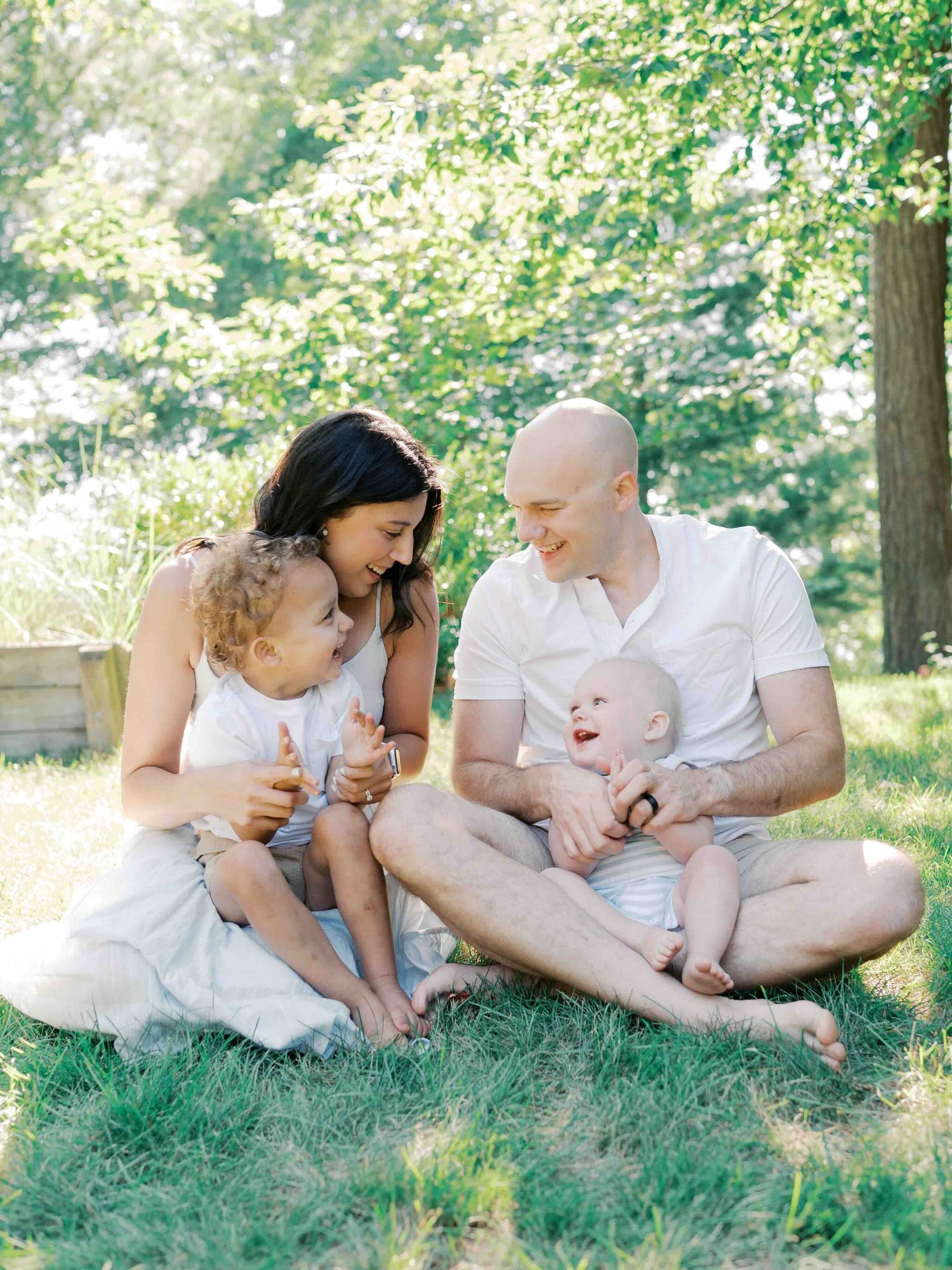 Two brothers playing with their parents during a candid family photo session in Mobile, Alabama.