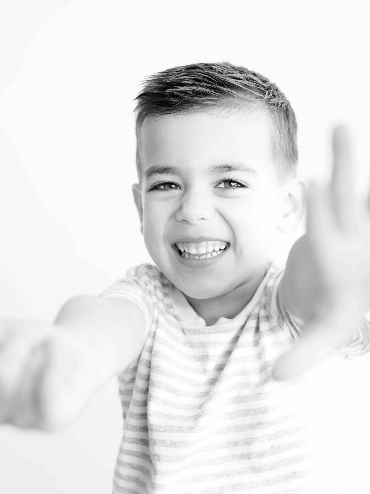 Child laughing during personality-focused portrait session in Mobile Alabama