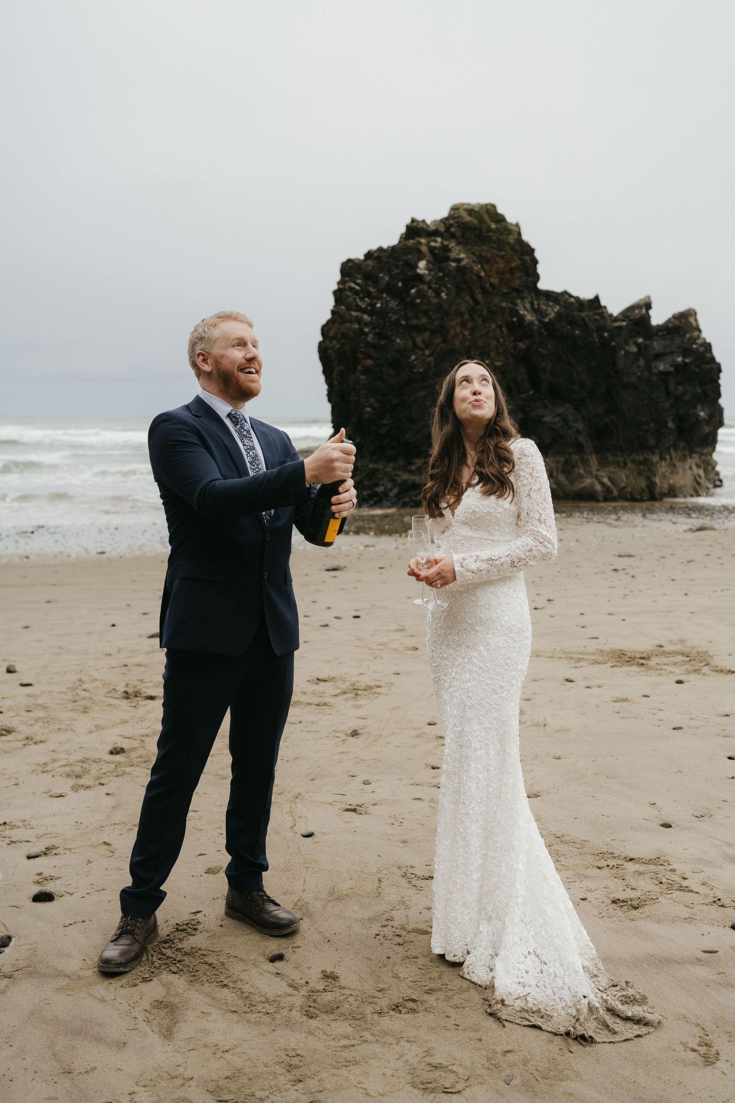 A celebratory moment on the beach with champagne during a wedding ceremony.