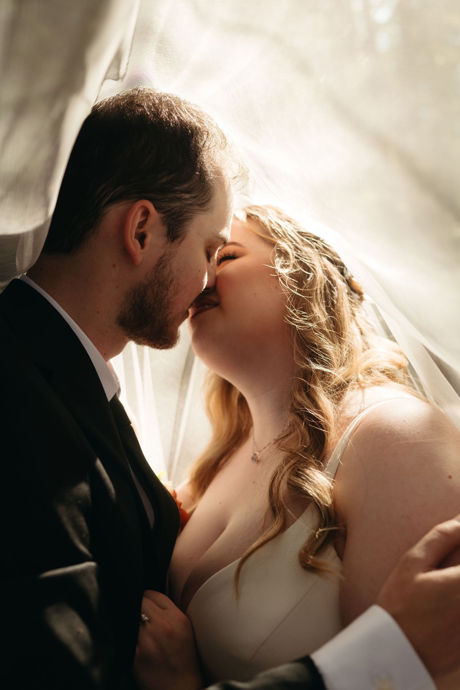 Intimate wedding portraits captured in soft, romantic lighting.