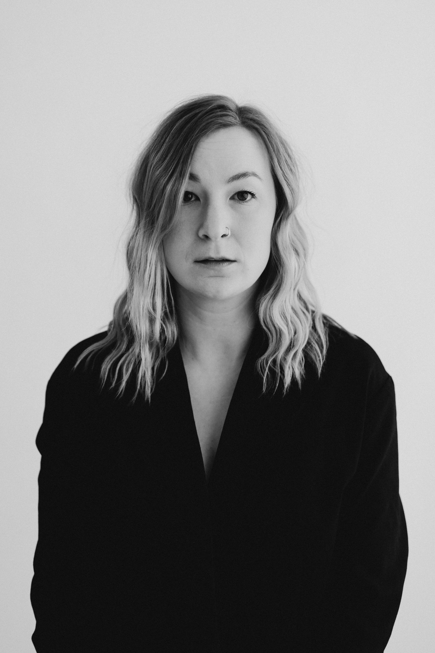 Artistic black and white portrait series showing different expressions and poses.