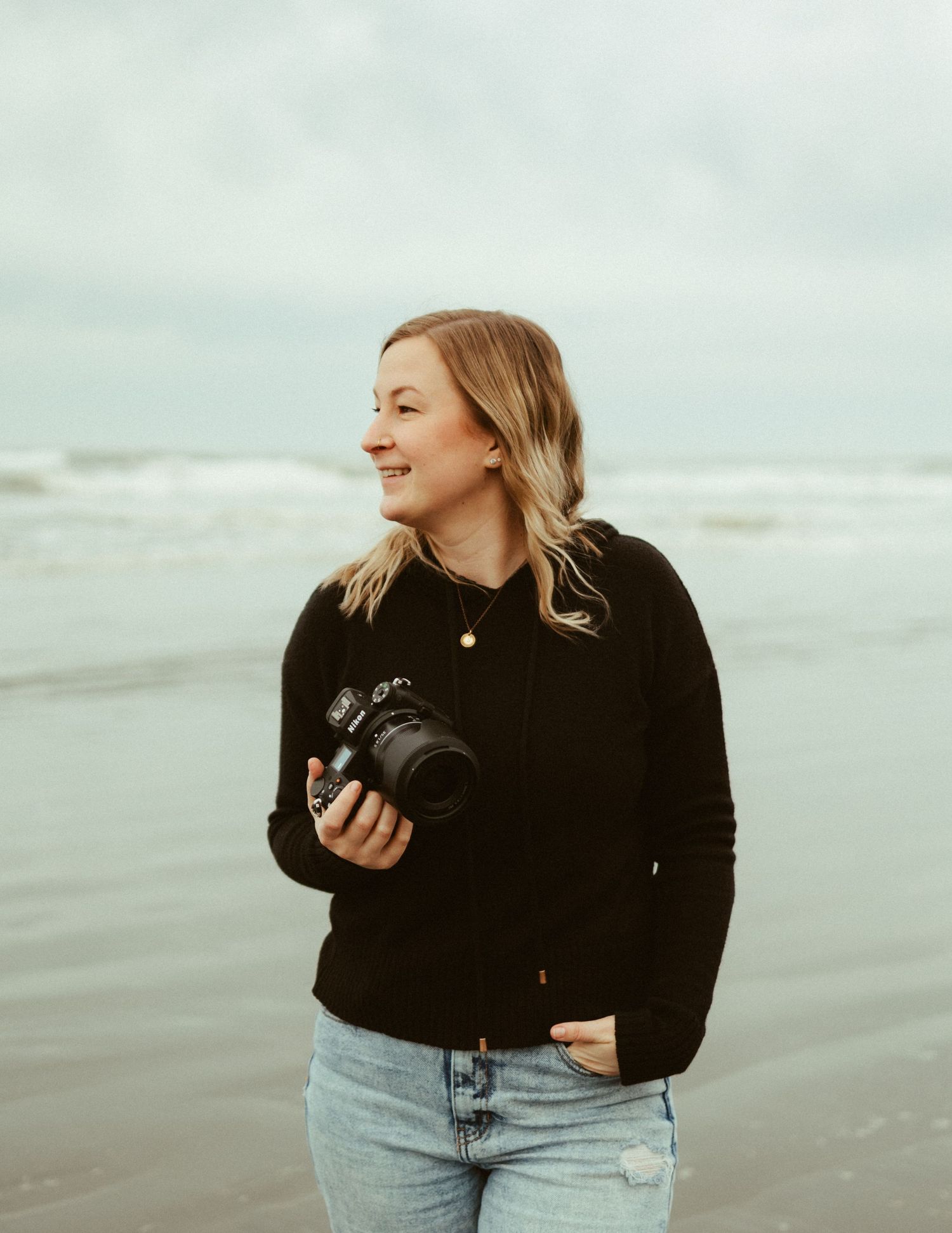 Candid shots of photographer at work on overcast beach.