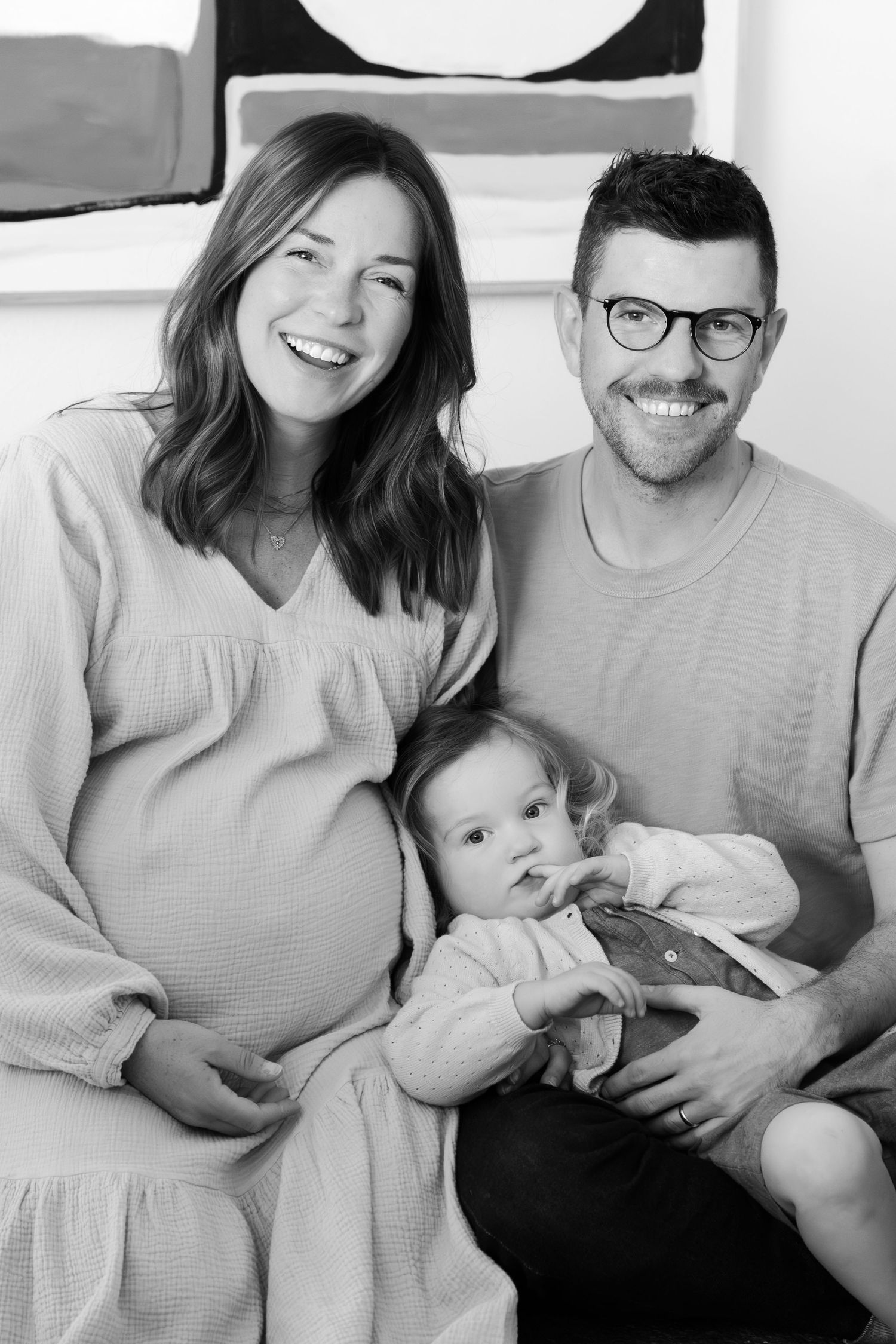 Black and white family photo with modern minimalist decor.