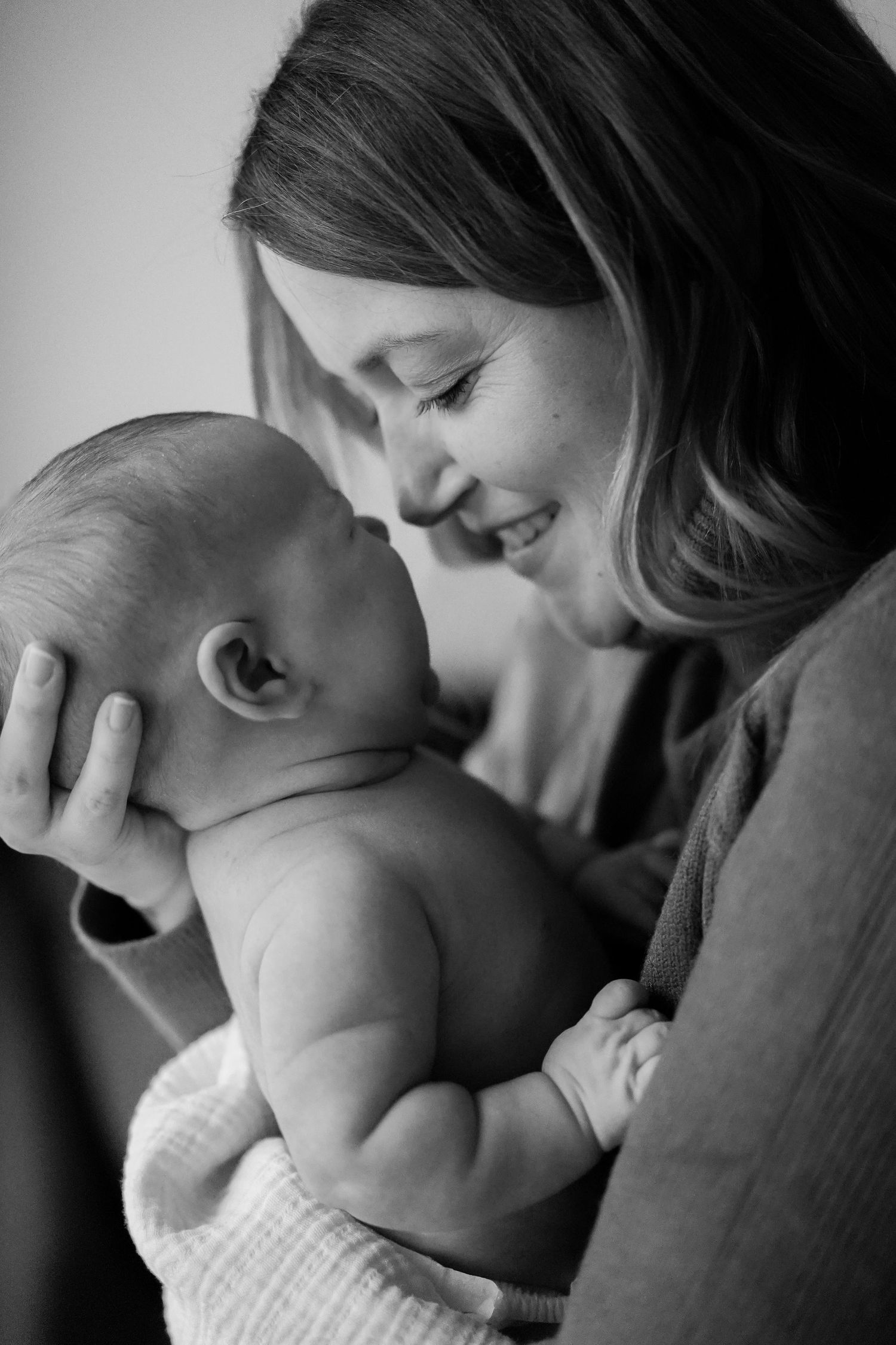 Black and white portrait capturing intimate bonding moment with baby.