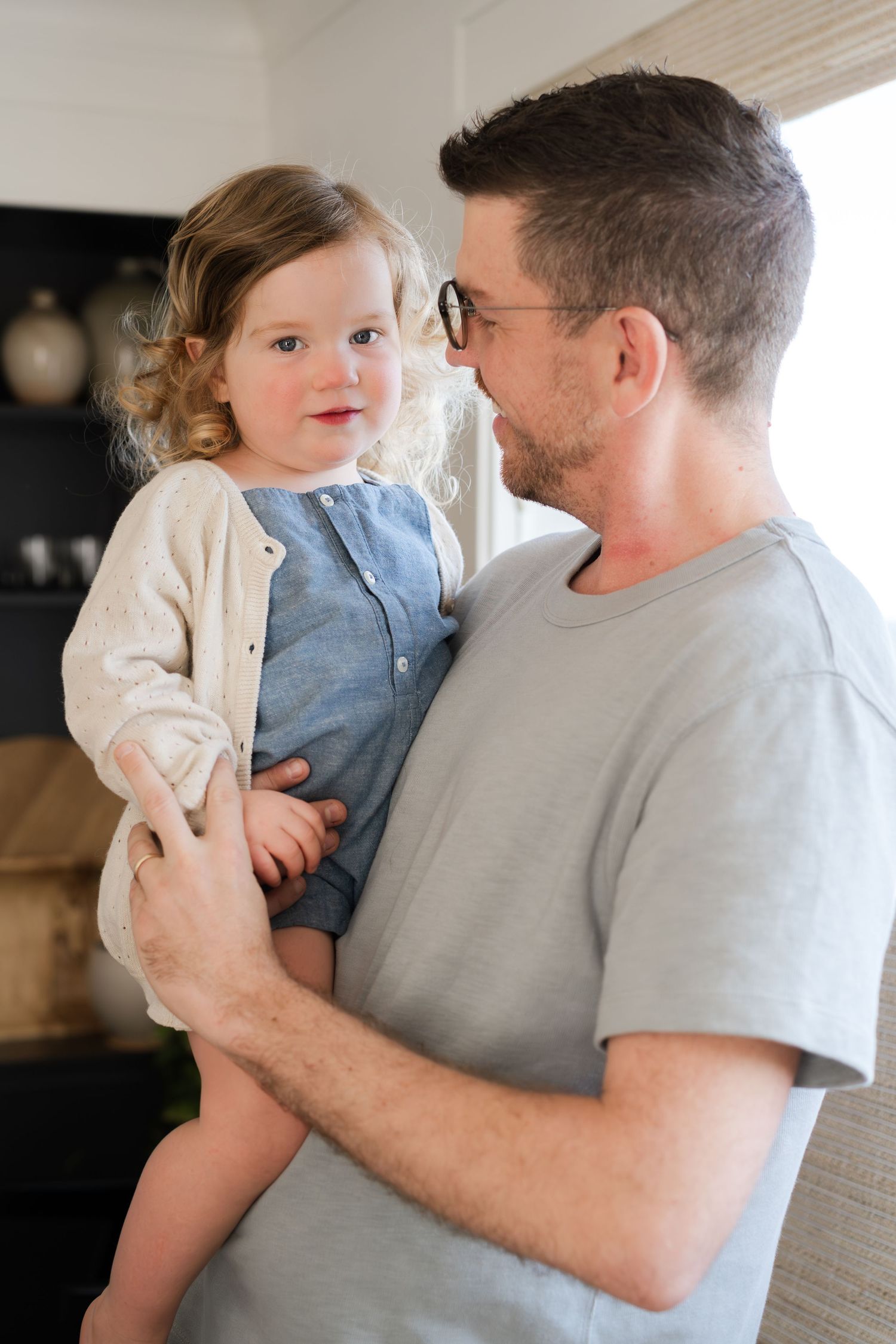 An intimate moment between parent and child in a modern home setting.
