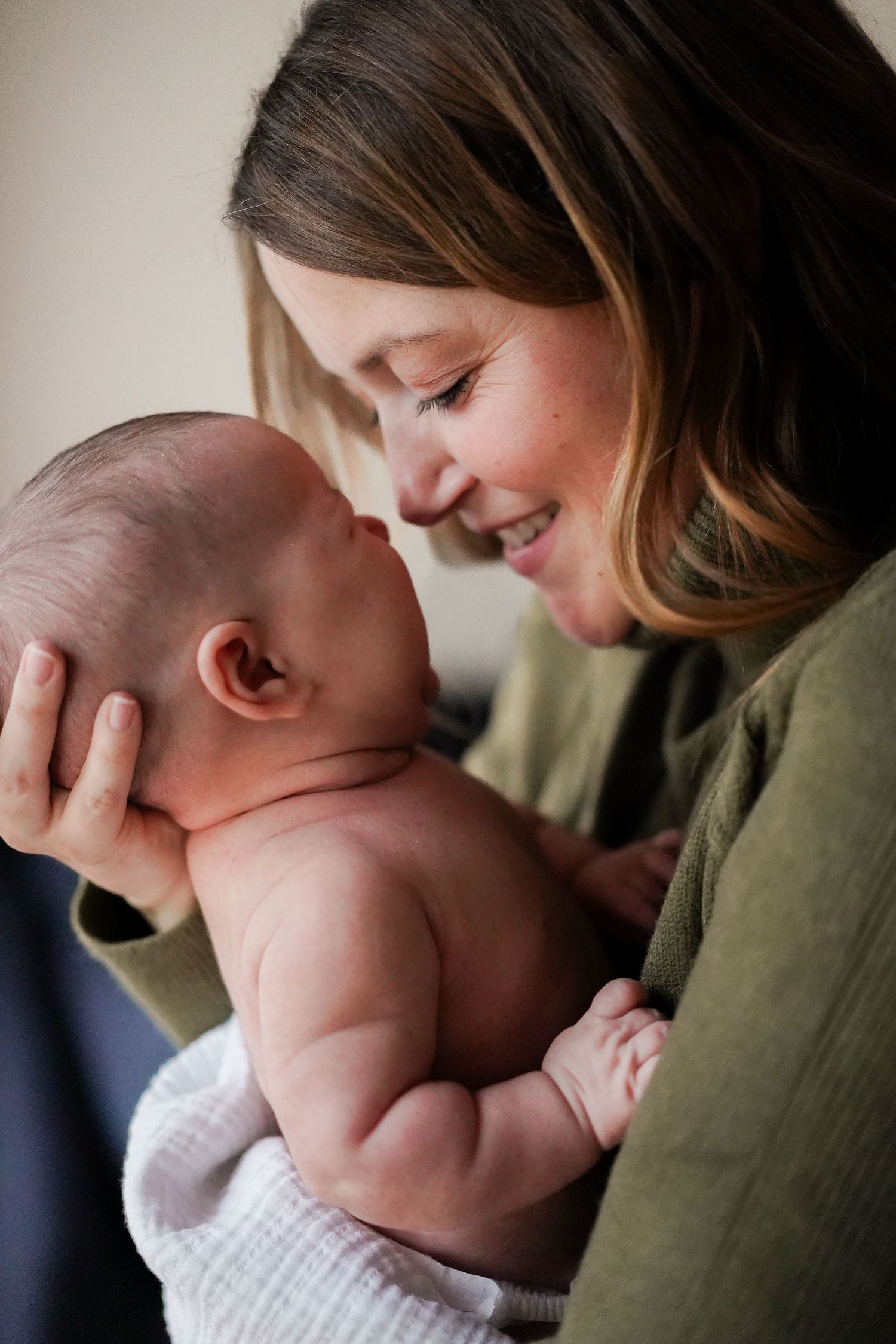 Tender moment between parent and baby showing loving connection and care.
