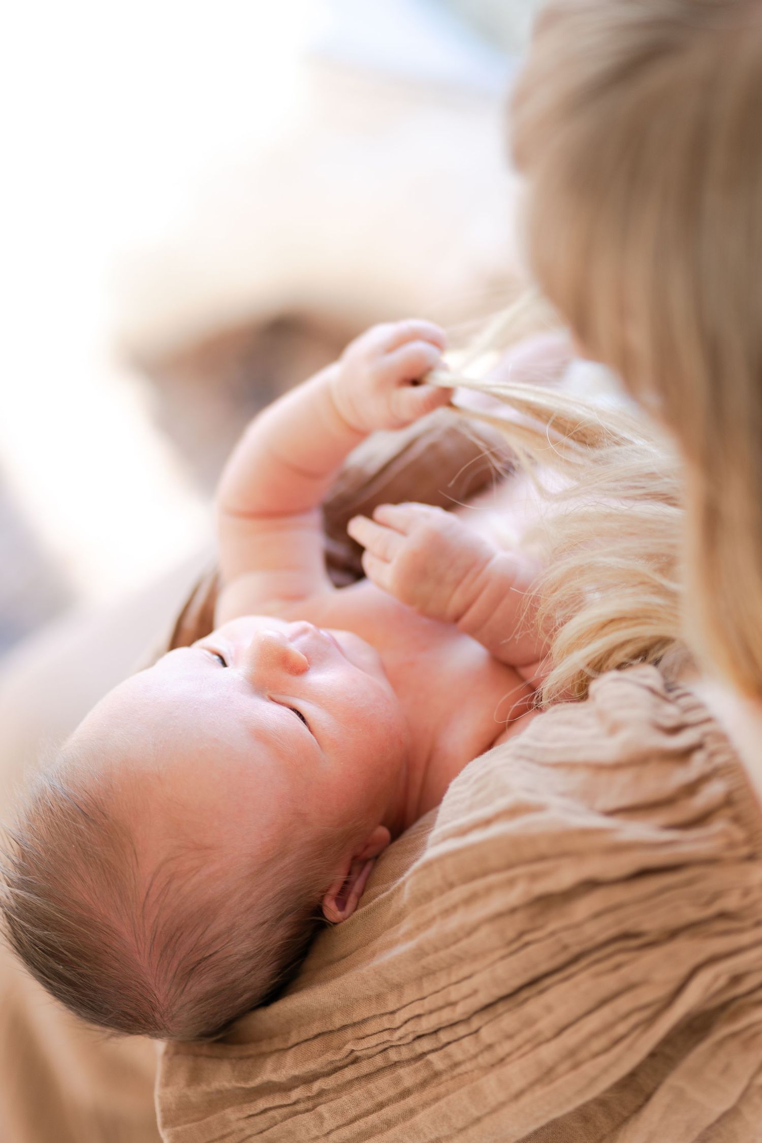 Close-up portrait series of a sleeping baby in soft lighting.