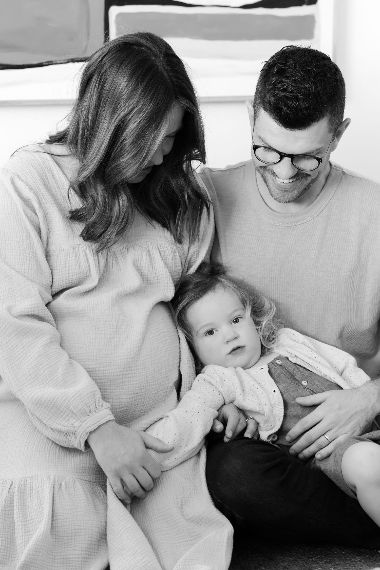 Black and white portrait of intimate family moments on a couch.