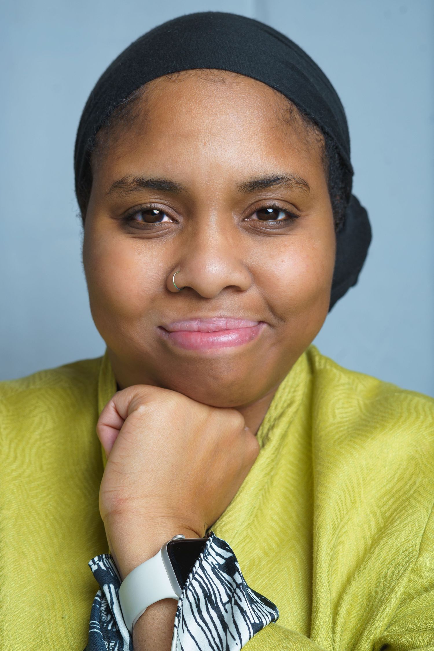 Close-up portrait photograph of a woman looking directly at the camera,