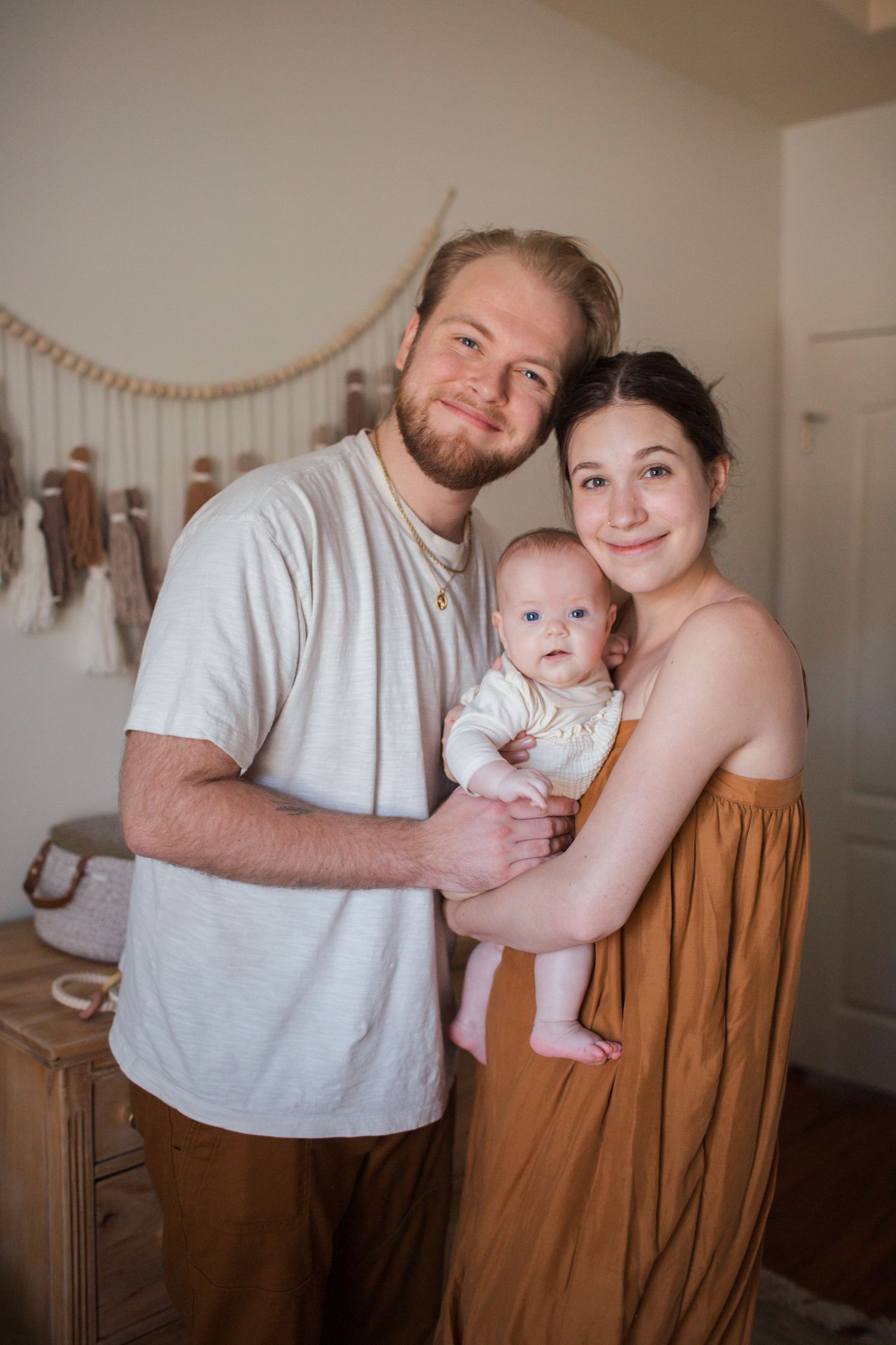 Mom hugging child during natural light indoor family portrait session