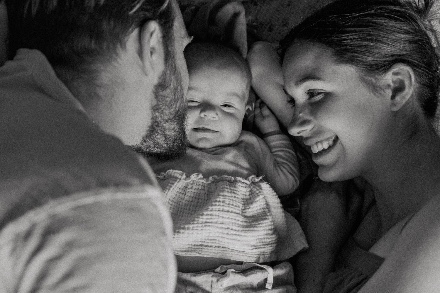 Mom hugging child during natural light indoor family portrait session