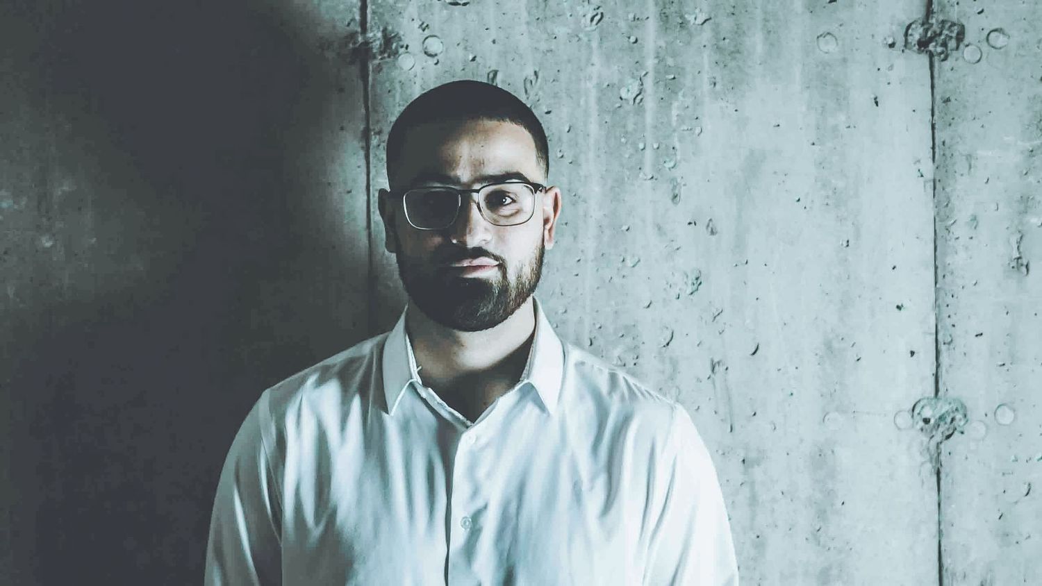 Contemporary business portraits with industrial concrete wall background.