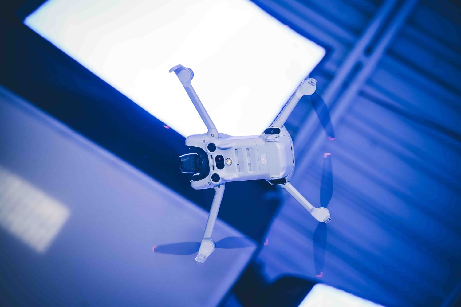 Close-up shot of a white drone propeller against a blue background.