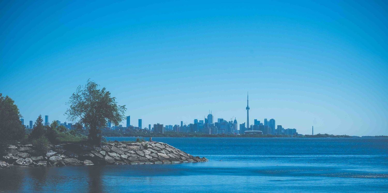 Panoramic skyline view of Toronto waterfront and Lake Ontario.