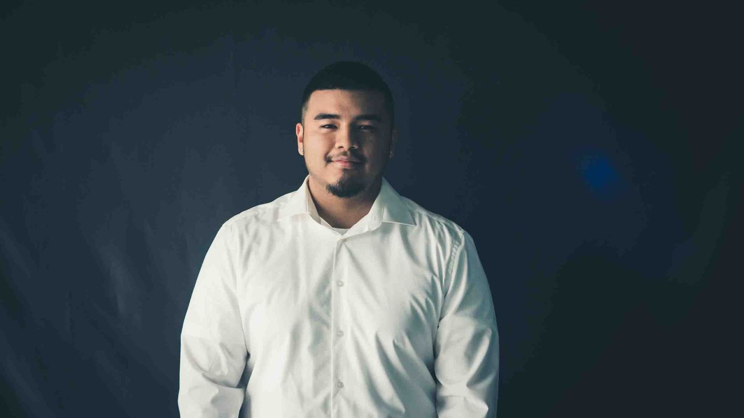 Portrait series against dark background wearing white clothing.
