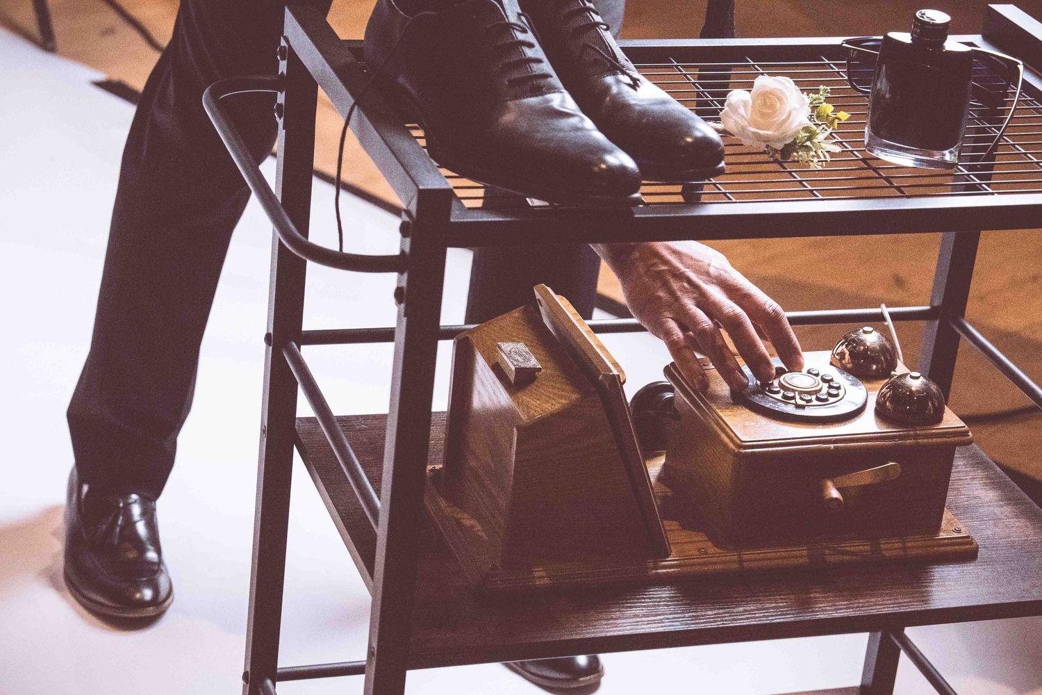 Customers sit at a modern coffee shop counter with stools and drinks while baristas work behind the bar.