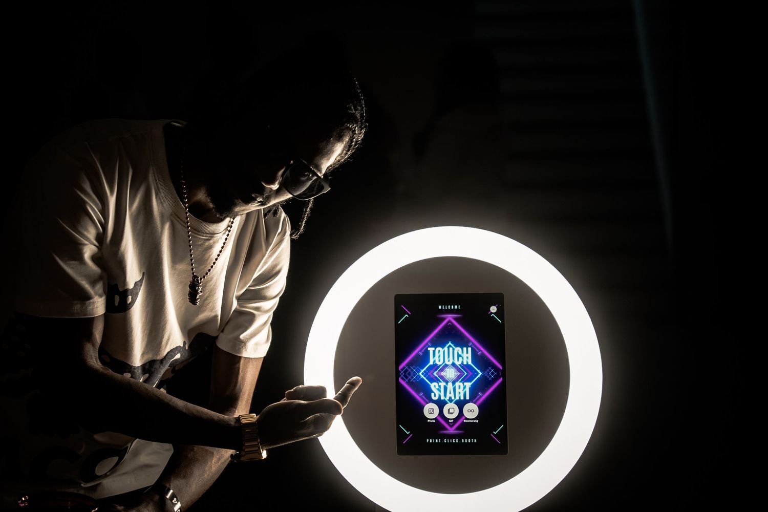 Gaming interface displayed through glowing ring light in darkness.