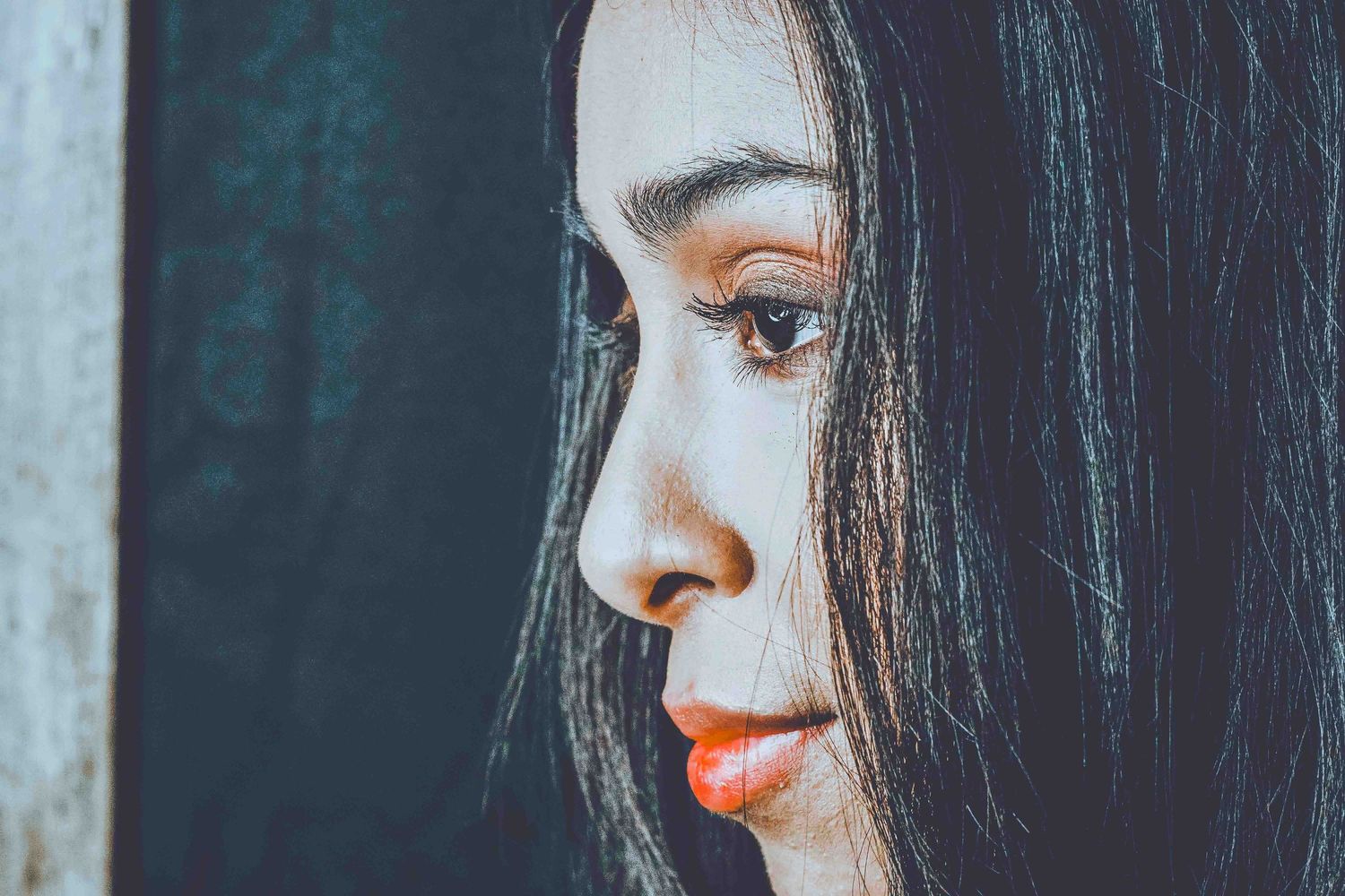 Series of profile shots showing dark hair and makeup details against blue background.