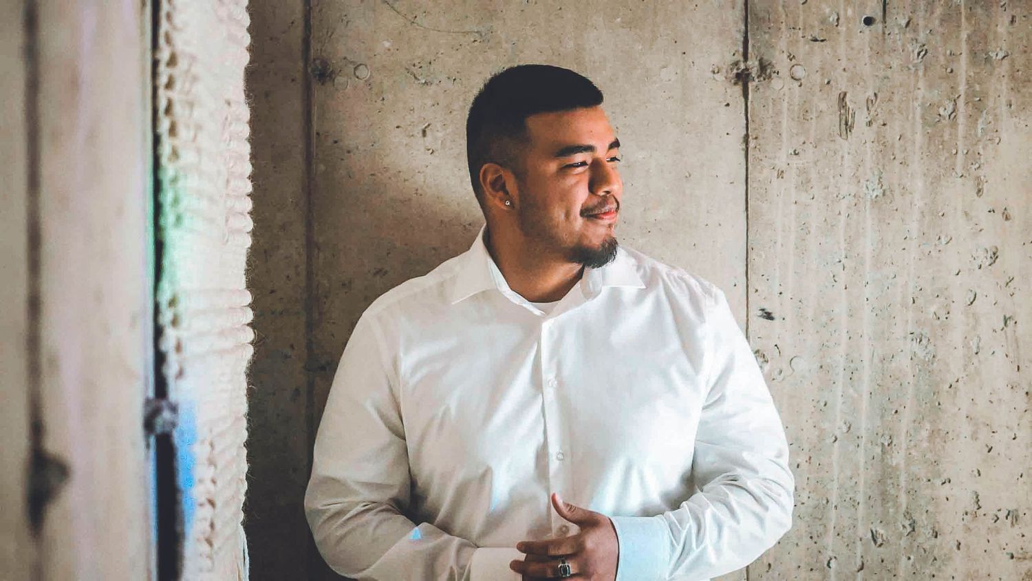 Professional portraits showing different poses against concrete wall.