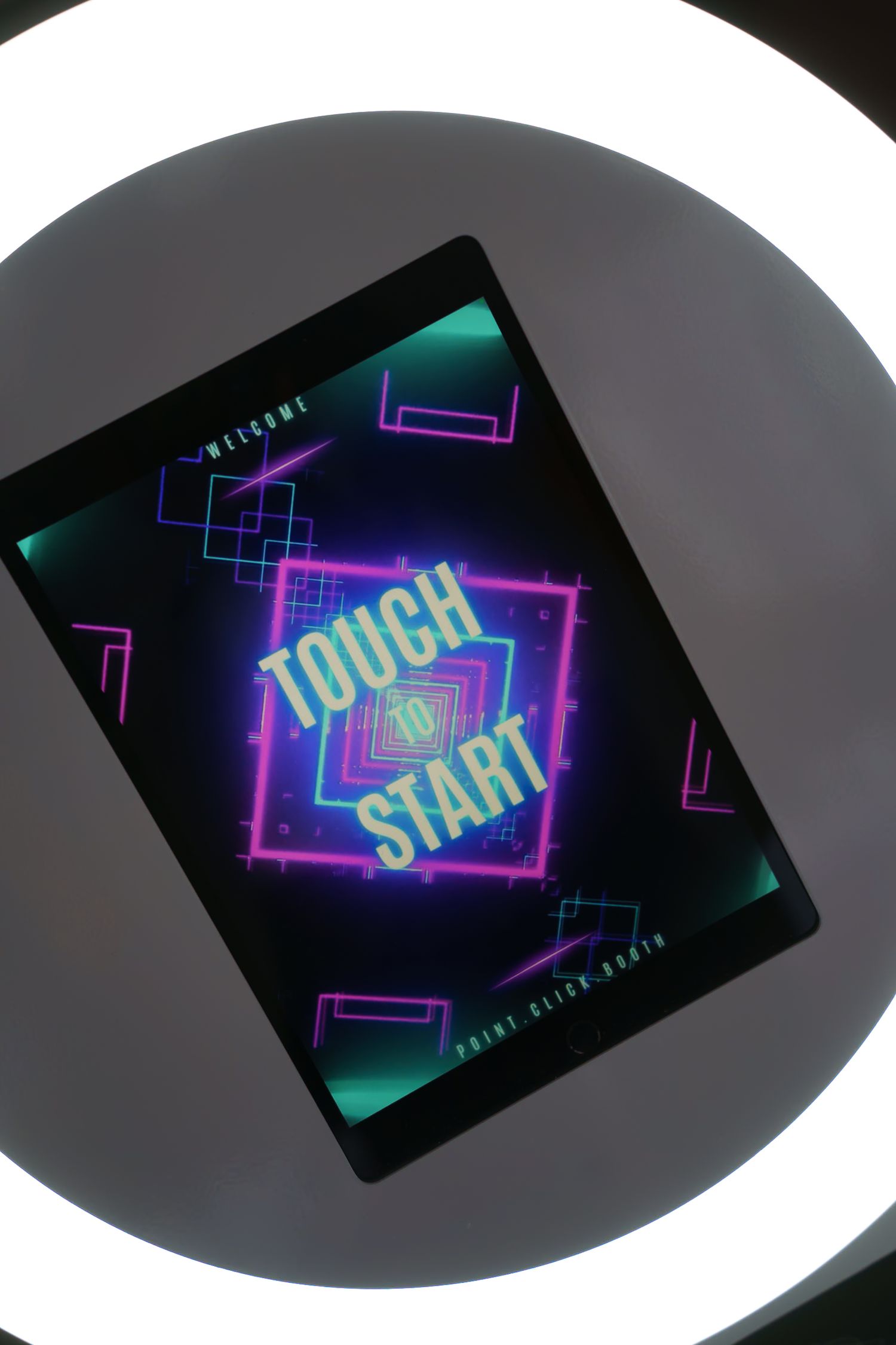 Vibrant neon touch start interface with angular patterns in cyan and magenta against black background.