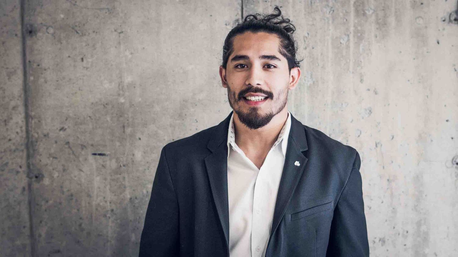 Series of professional portraits against concrete wall showing confident poses.