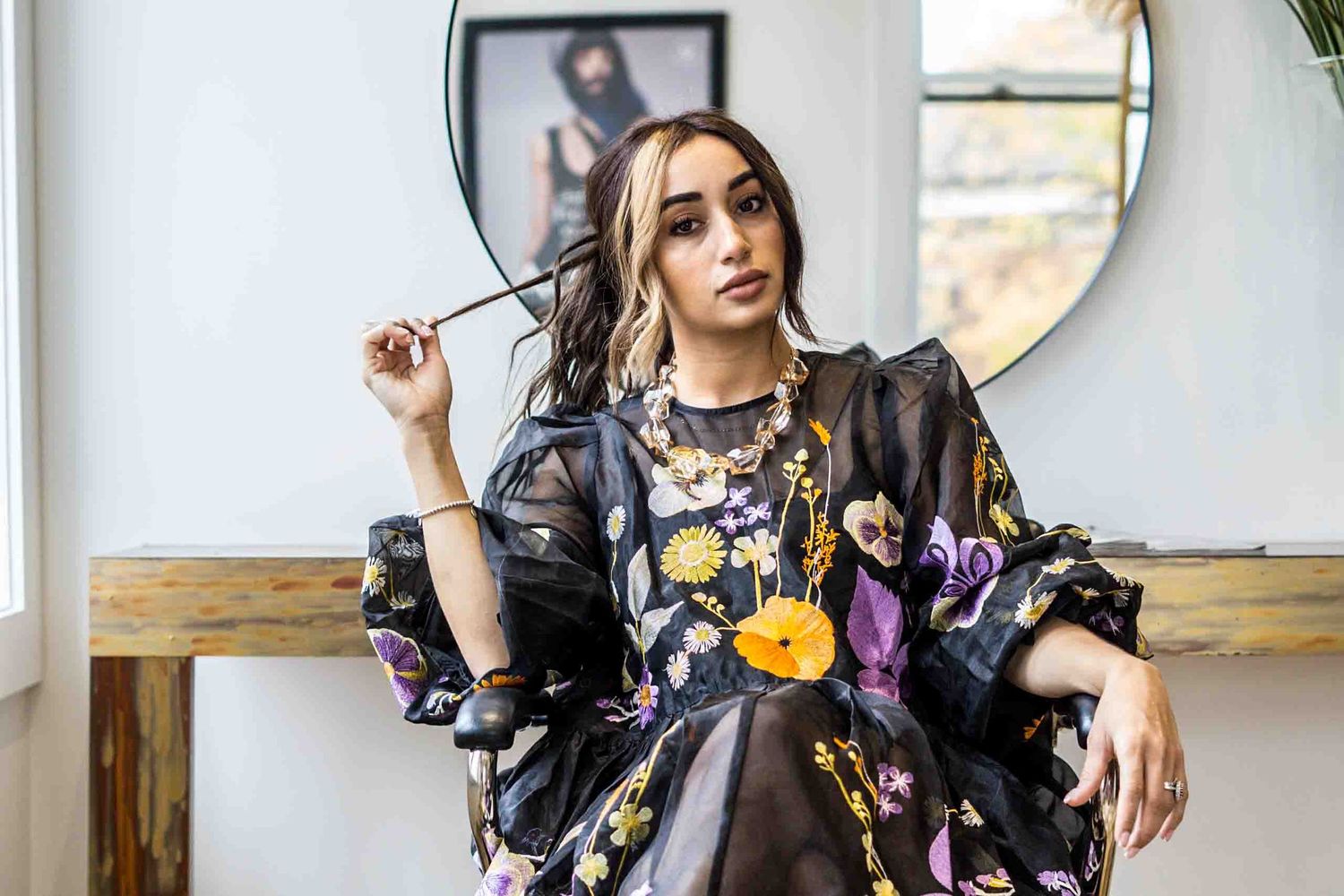 Fashion portraits in floral print dress against bright studio backdrop with natural lighting.