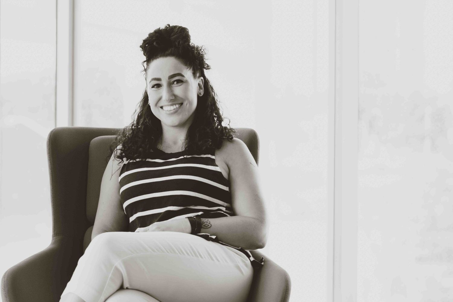 Professional portrait series showing relaxed expressions in a bright office setting.