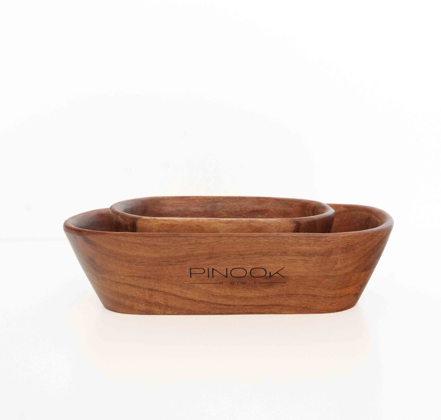 Set of three nested wooden serving bowls with engraved PINOOK logo, crafted from rich warm-toned acacia wood.