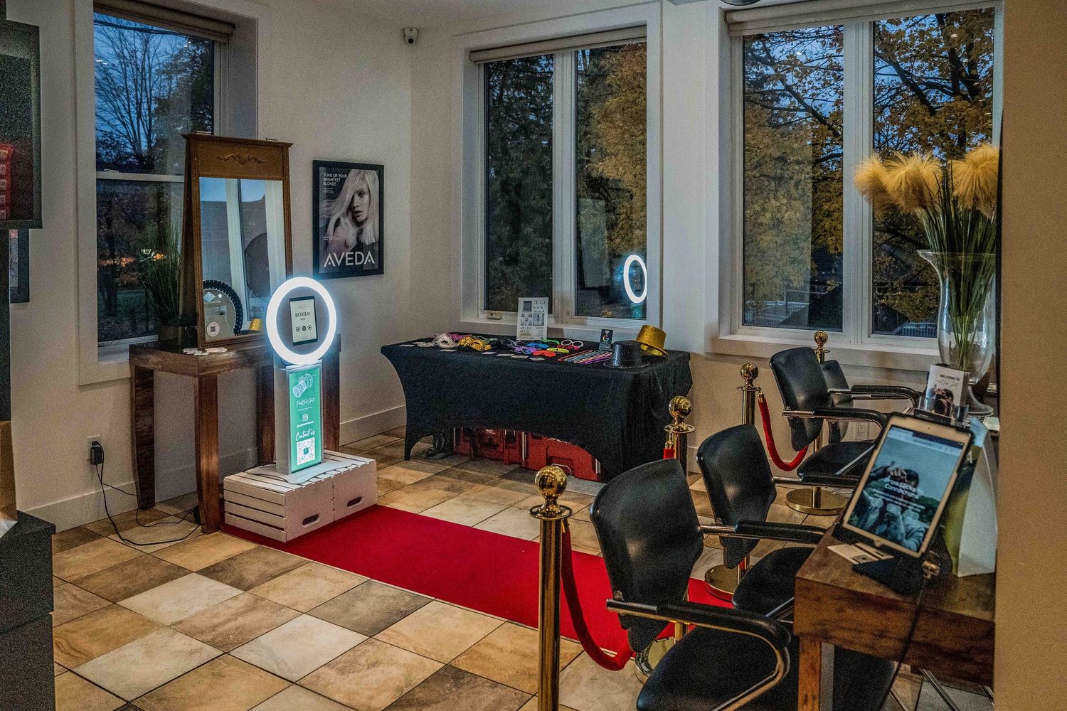 Spacious salon interior with floor-to-ceiling windows and red carpet walkway.