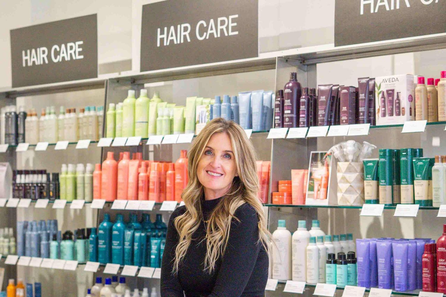 Hair salon interior showing extensive display of professional hair care products and styling solutions.
