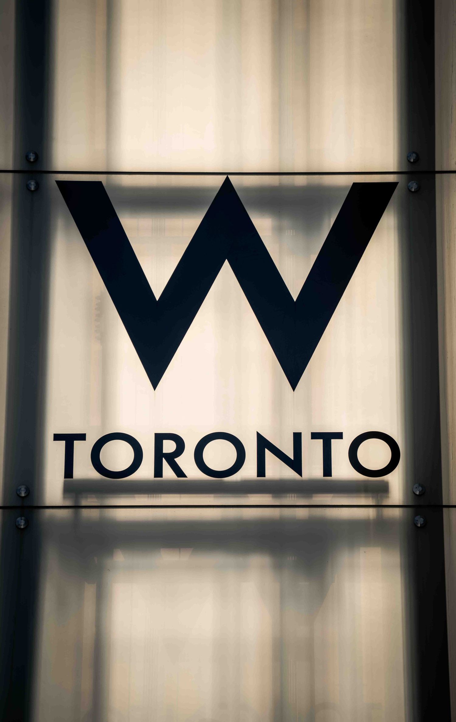 Minimalist signage displaying 'TORONTO' in geometric black letters against light background.