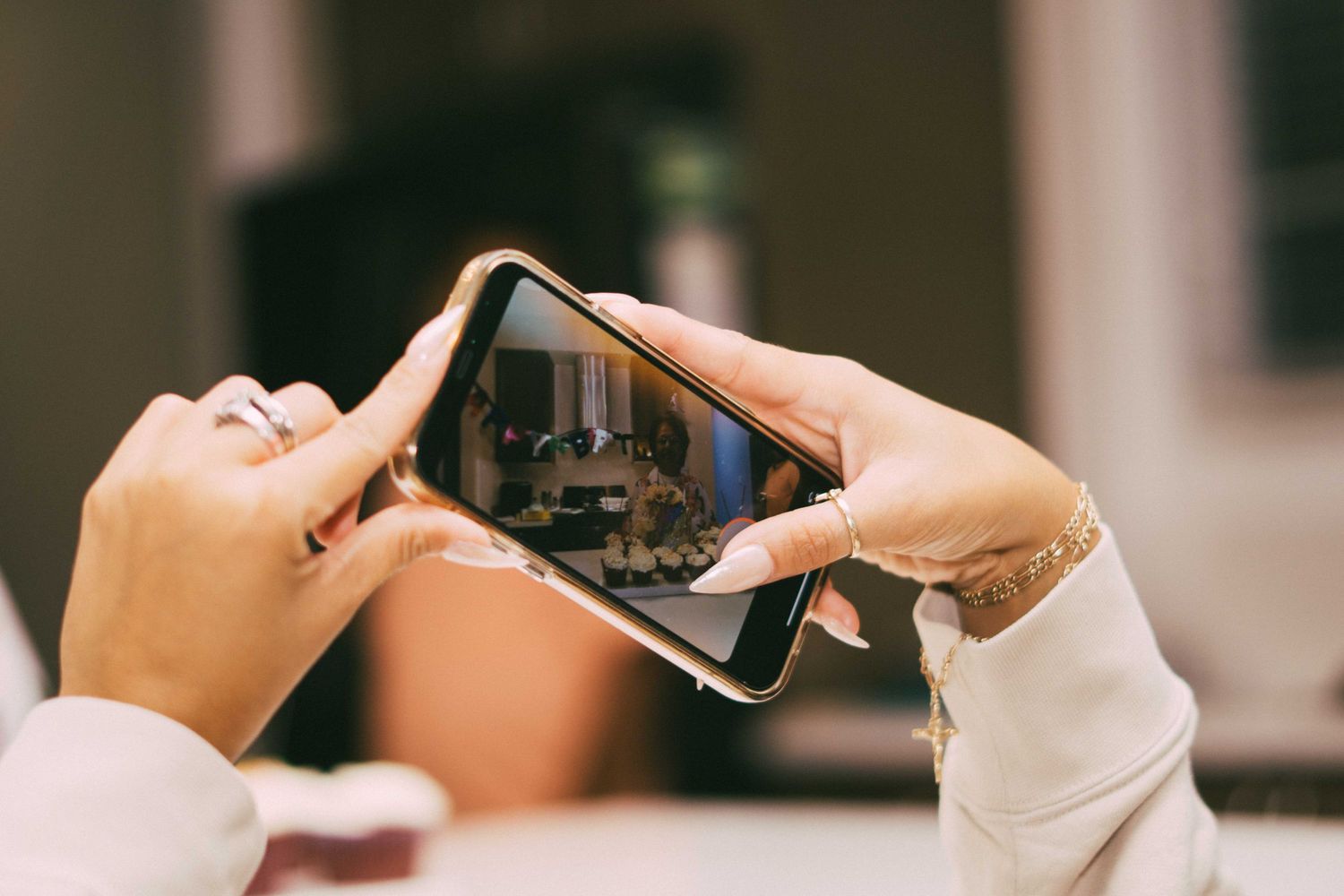 Close-up view of hands holding smartphones during an event.