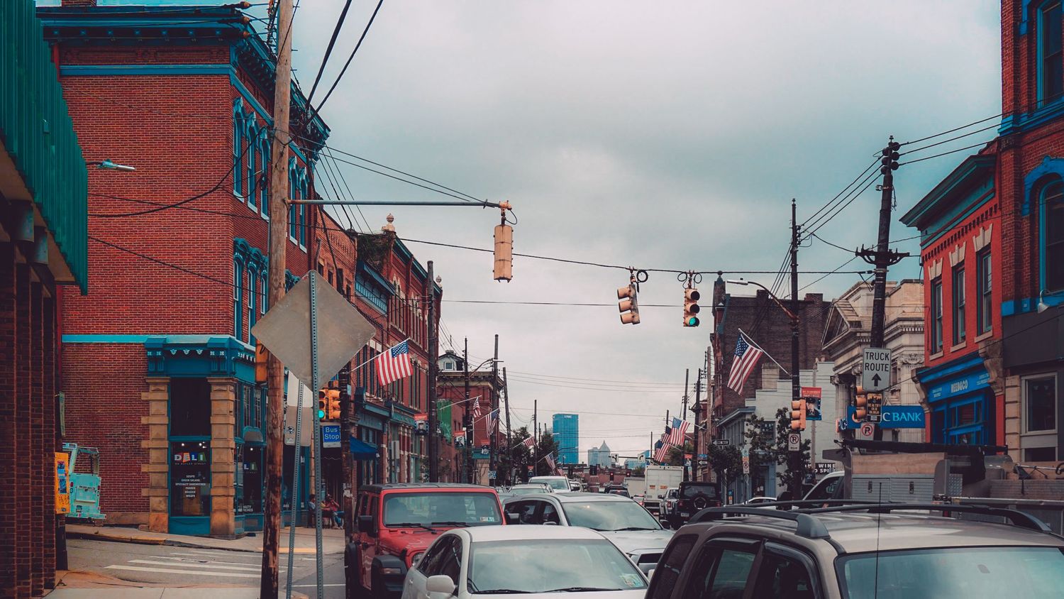 Panoramic view of historic brick buildings and storefronts along a city street.