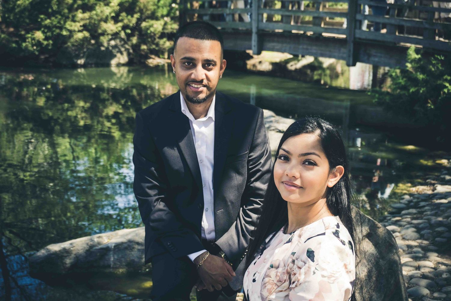 A couple shares tender moments on garden steps surrounded by spring foliage.