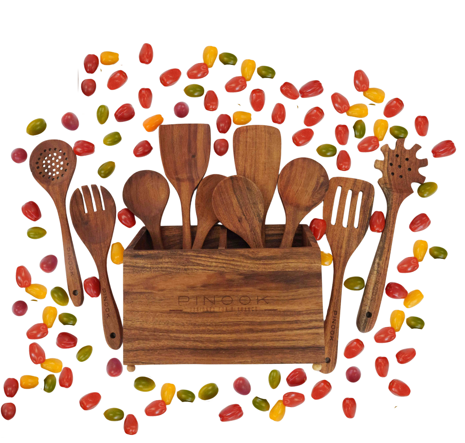 Wooden kitchen utensil set in a rustic holder surrounded by colorful jelly beans on a white background.
