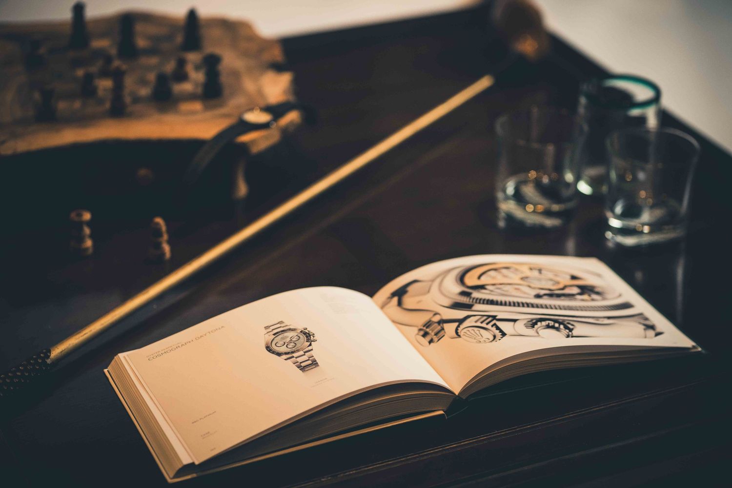 Open notebook with pencil and artistic sketches on dark wooden table in moody lighting.
