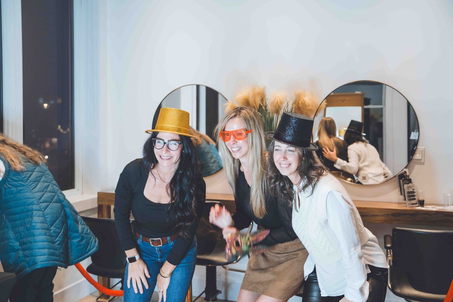 Group of people gathered around a table in a casual indoor setting.