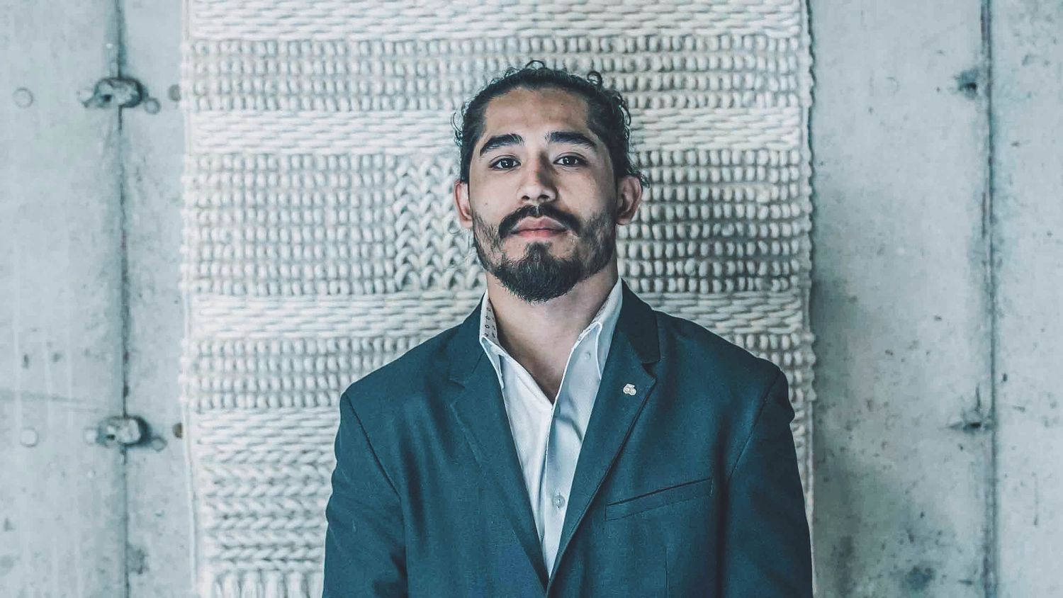 Series of professional headshots arranged horizontally against concrete background.