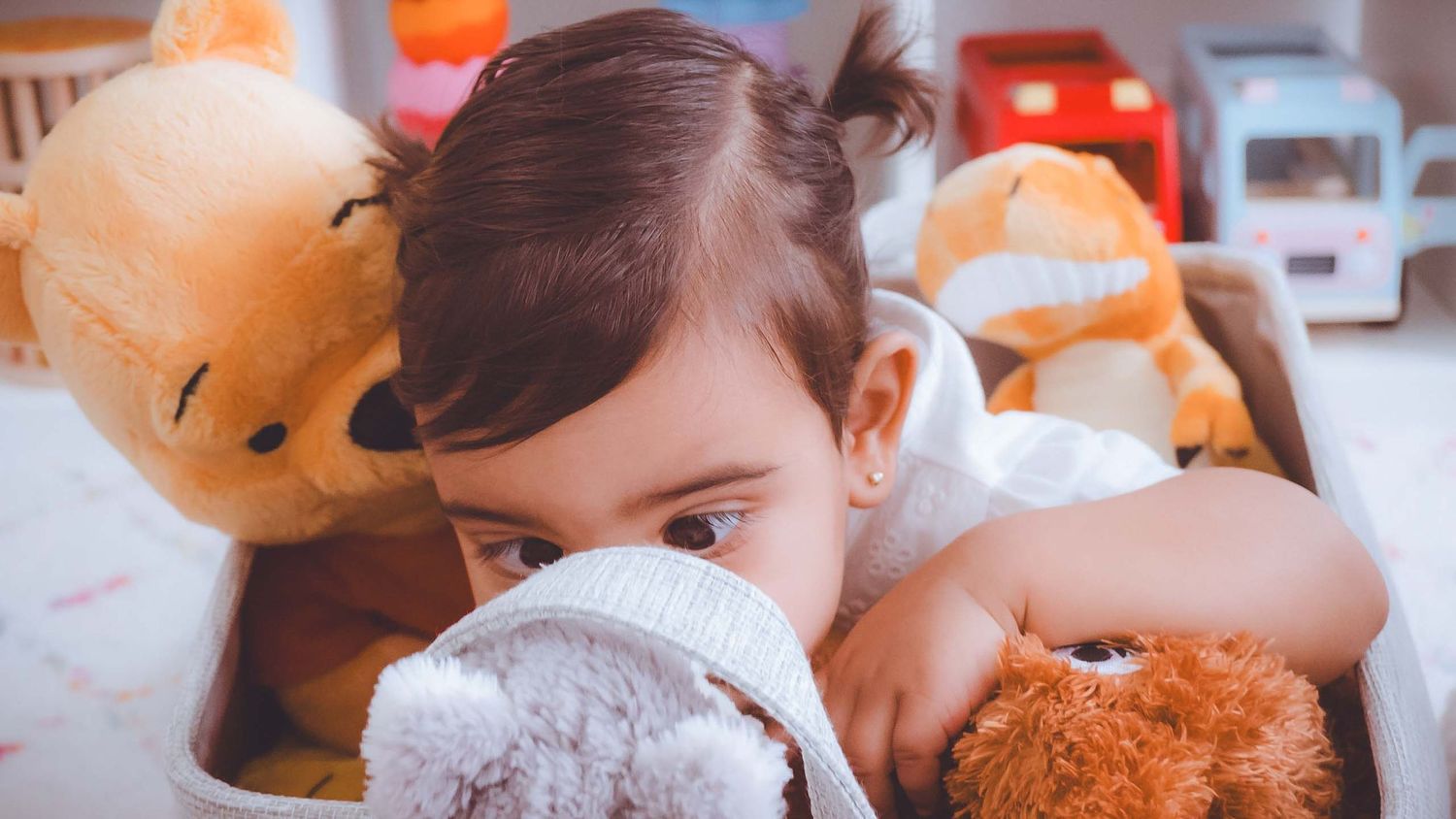 Close-up shots of a baby with orange decorative elements in the background.