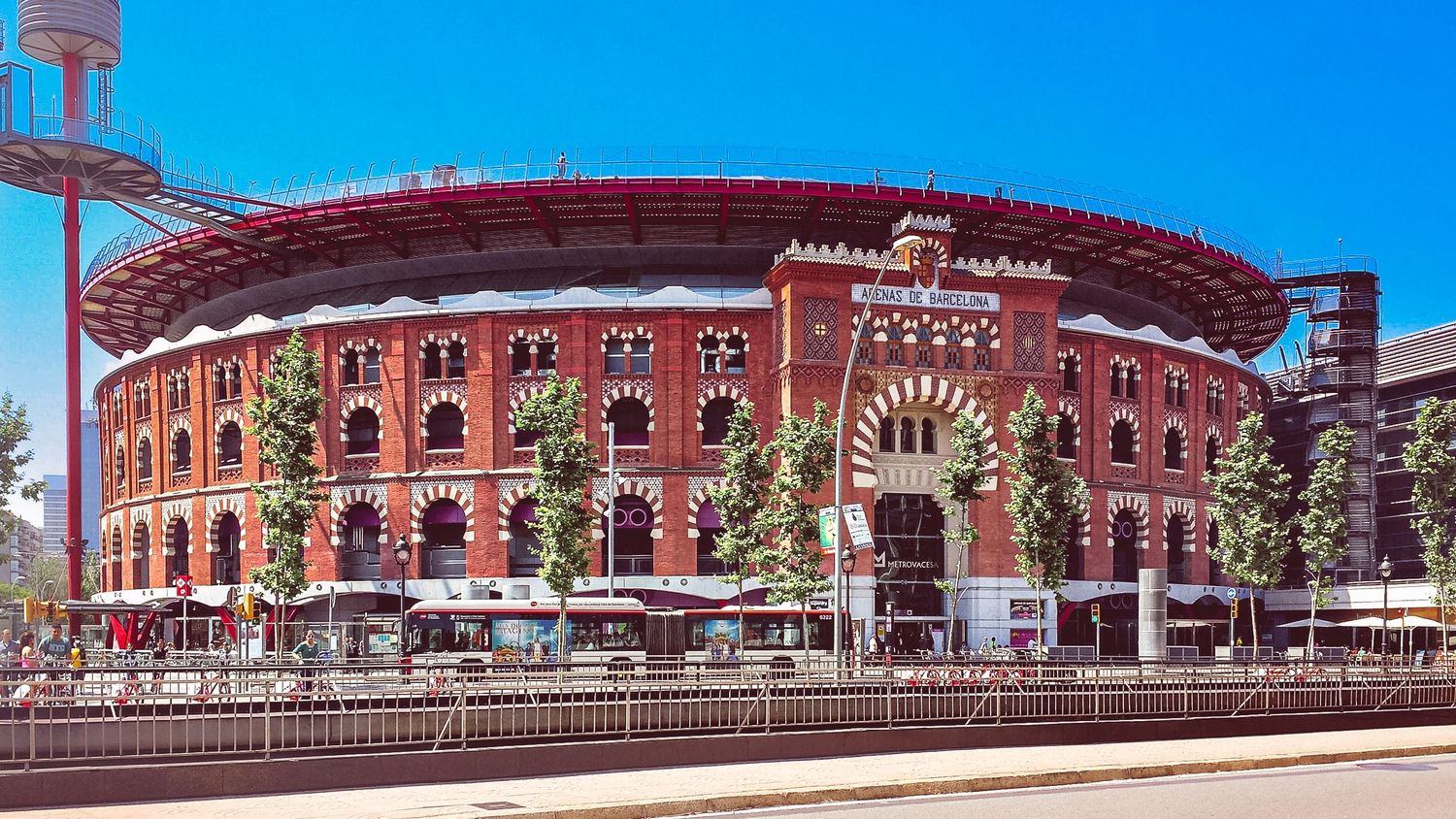 Panoramic view of red brick stadium or arena architecture with classical design elements.