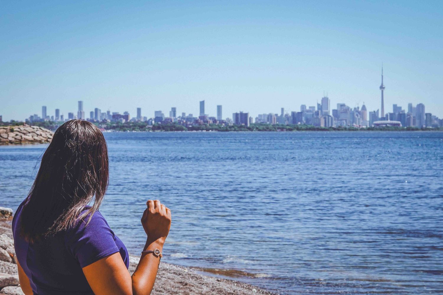 Beautiful view of Toronto's skyline across the calm blue waters of Lake Ontario.