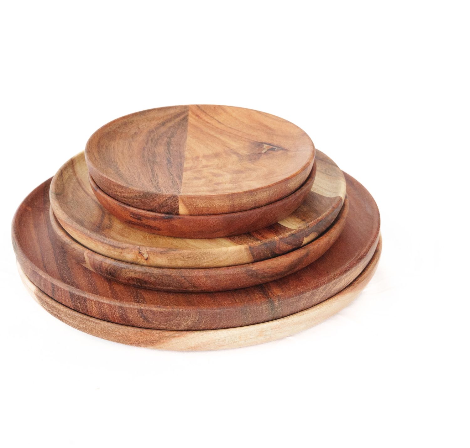Set of four round acacia wood serving plates in graduated sizes showing natural wood grain patterns.
